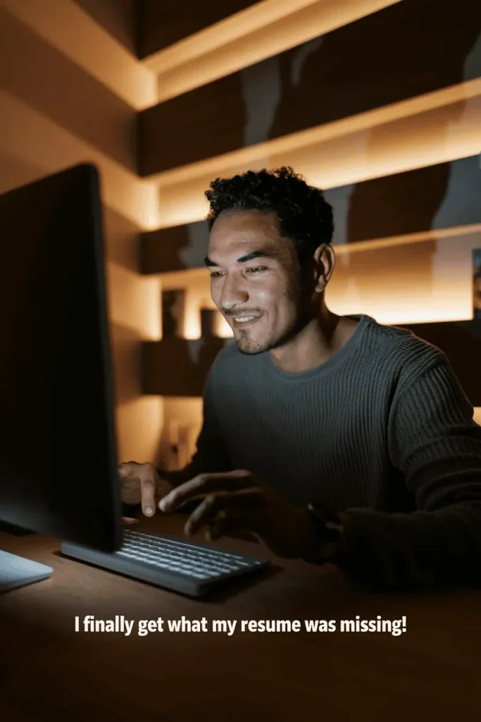 man at computer fixing resume